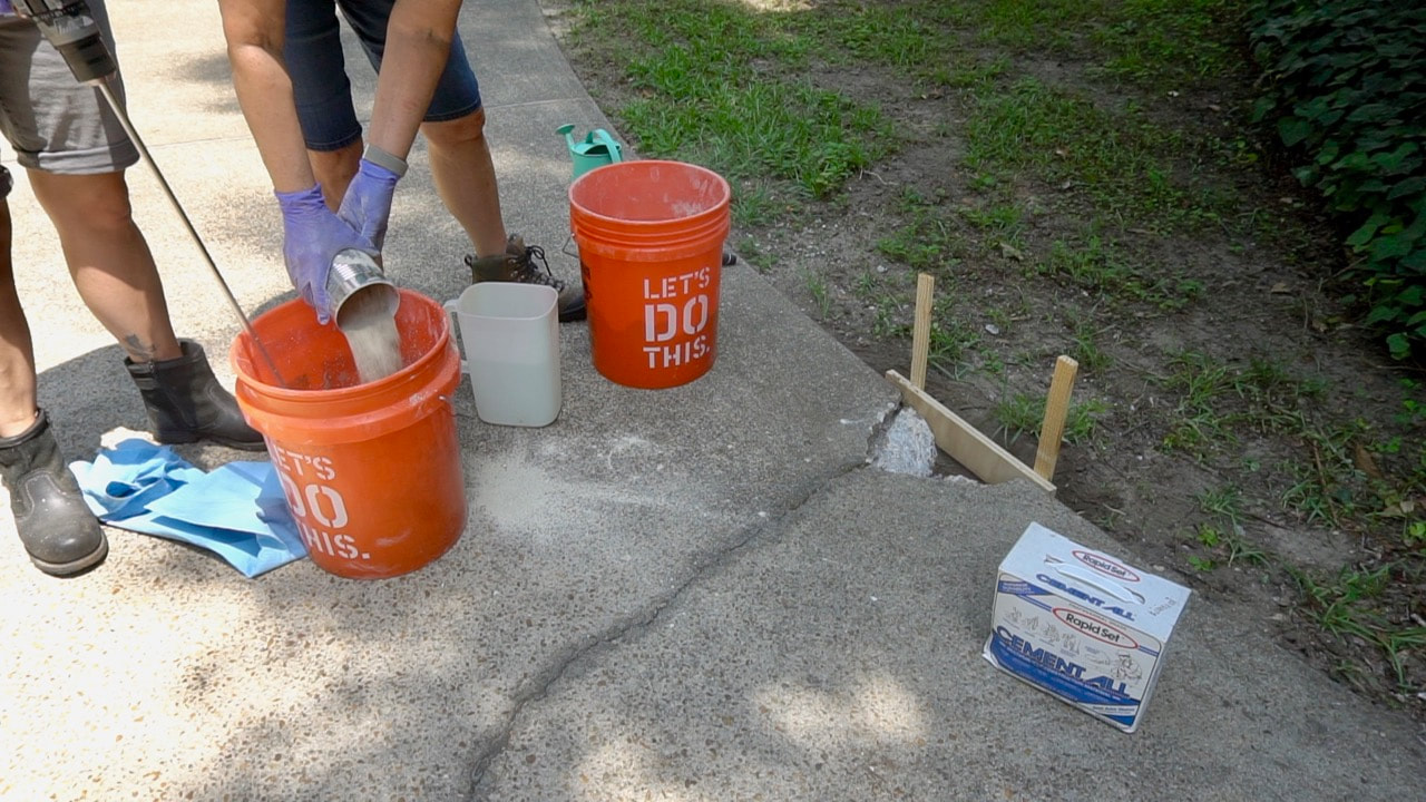 Mixing up Rapid Set Cement All to make the concrete rapir.