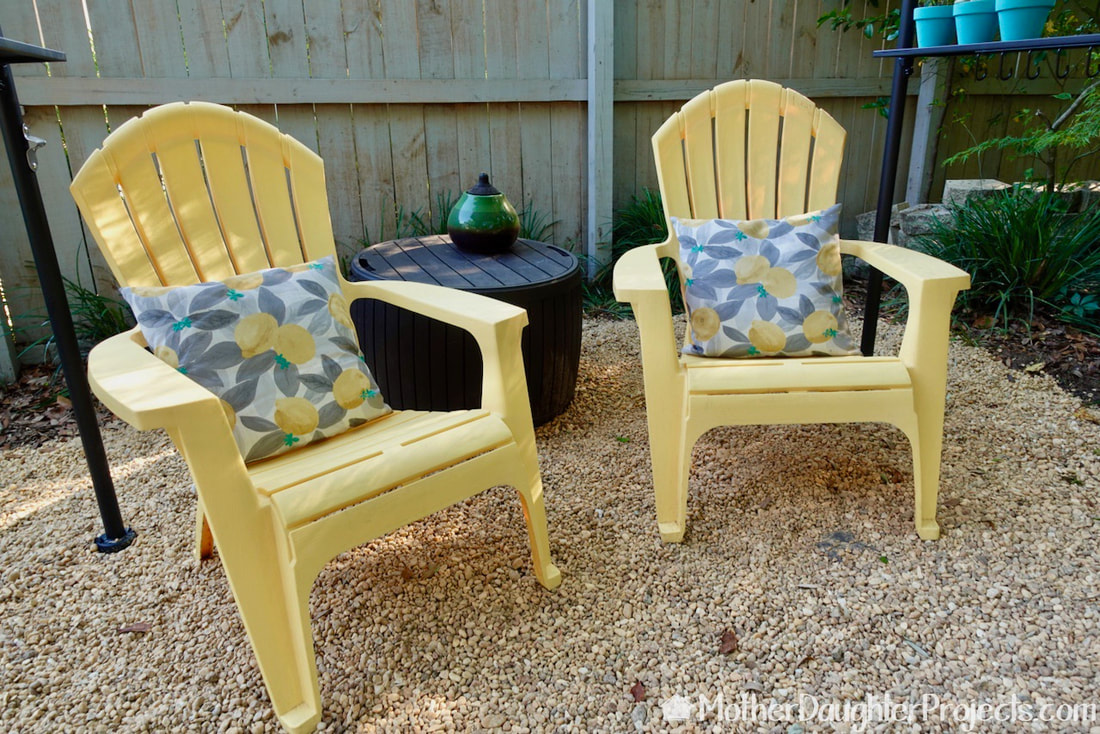 A couple of chairs with comfy pillows create a calming restful spot to chill in the backyard.
