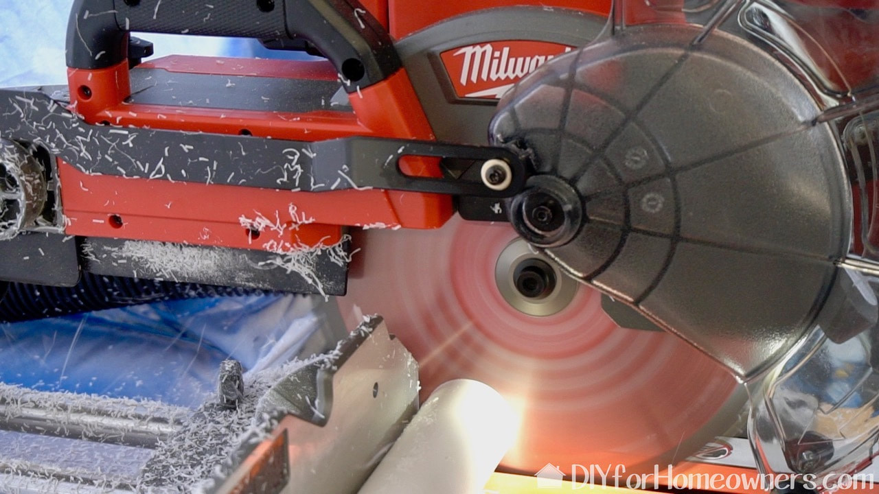 Using the Milwaukee battery powered miter saw to cut the PVC.