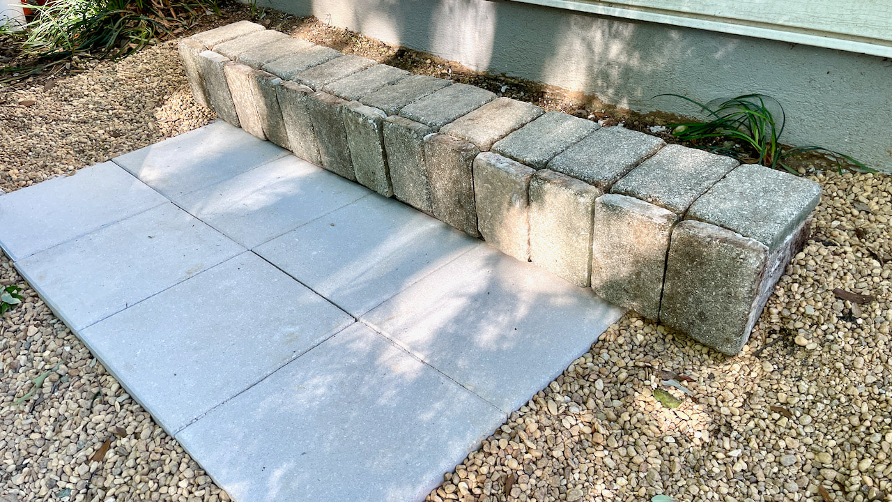 The pavers from the planter were reused to finish the wall.