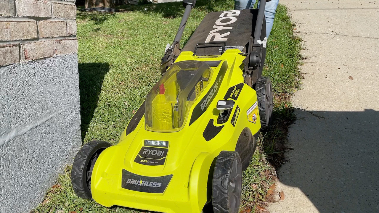 Showing the Ryobi cordless battery powered mower in action.