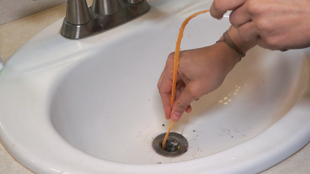 Use a plastic snake hair cleaning tool to remove clog. 