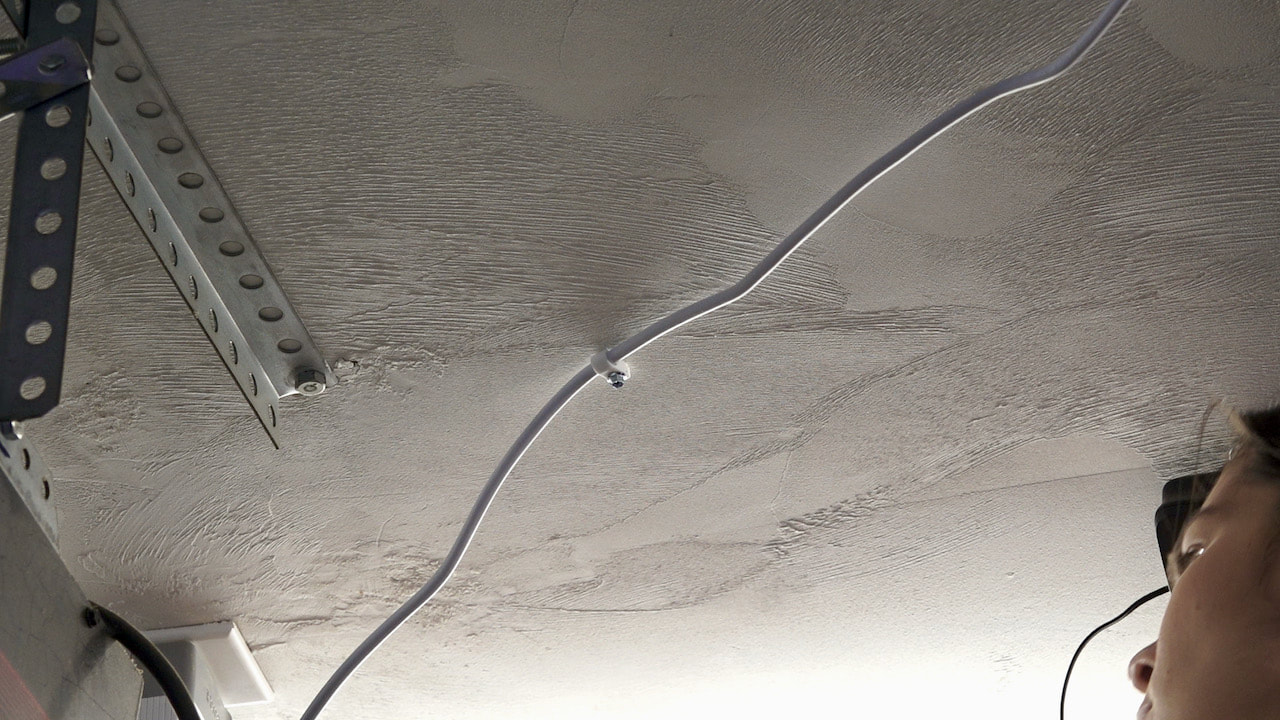 We used these nail in cable wire clips to keep the cords close to the ceiling. 