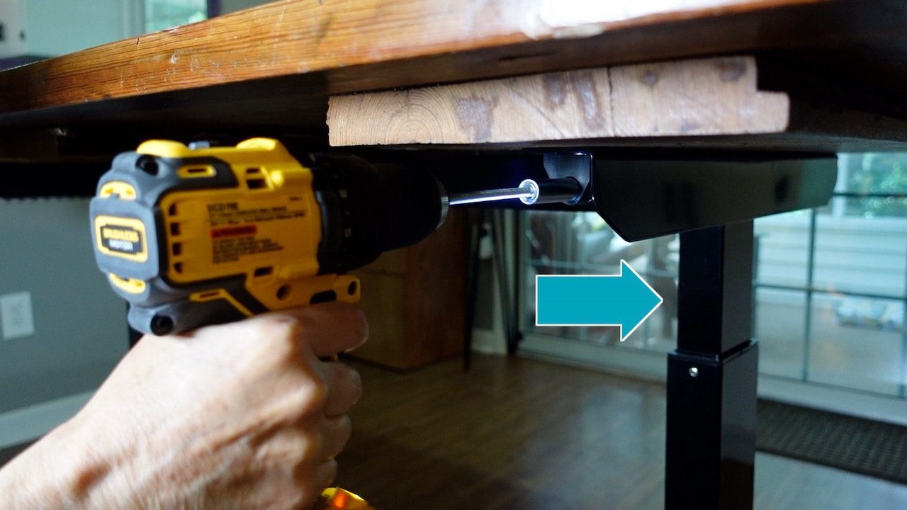 Using a DeWalt drill to lower the Husky work table. 