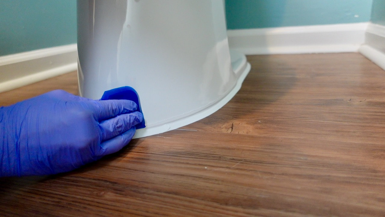 Using a DAP silicone caulking tool gave us professional results when caulking the toilet.