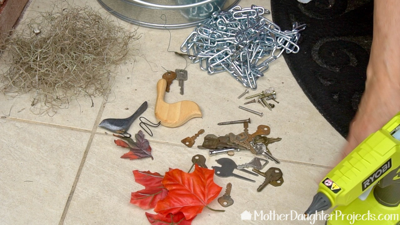 Use found objects like keys, leaves, and spanish moss to decorate your fall halloween tree.