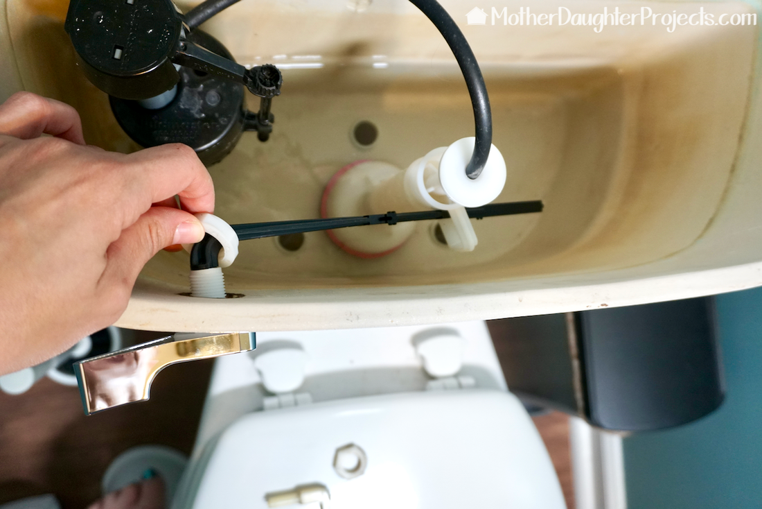 Add the toilet flush arm to the flush valve and tighten.