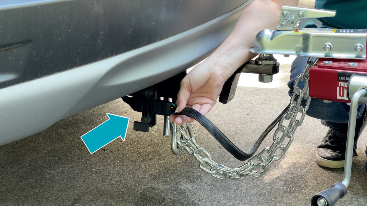 Install a tow hitch and electrical harness on your car before attempting to tow a utility trailer. 