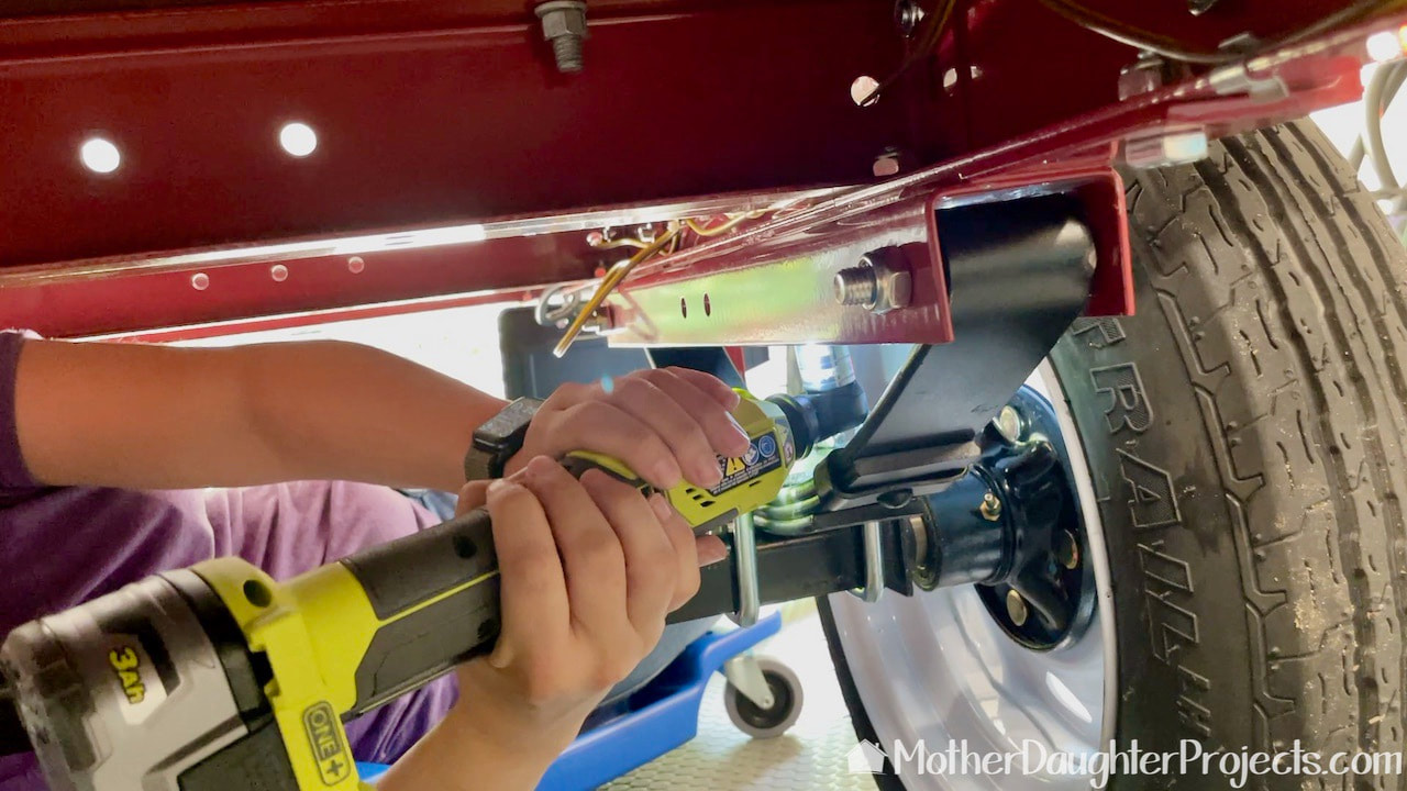 The Ryobi battery powered ratcheting wrench makes it easy to remove bolts. 