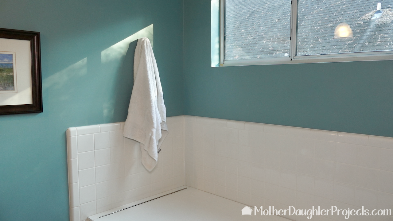 The wall portion can be used as a hook for bathrobe or towel when not holding the cover up. 